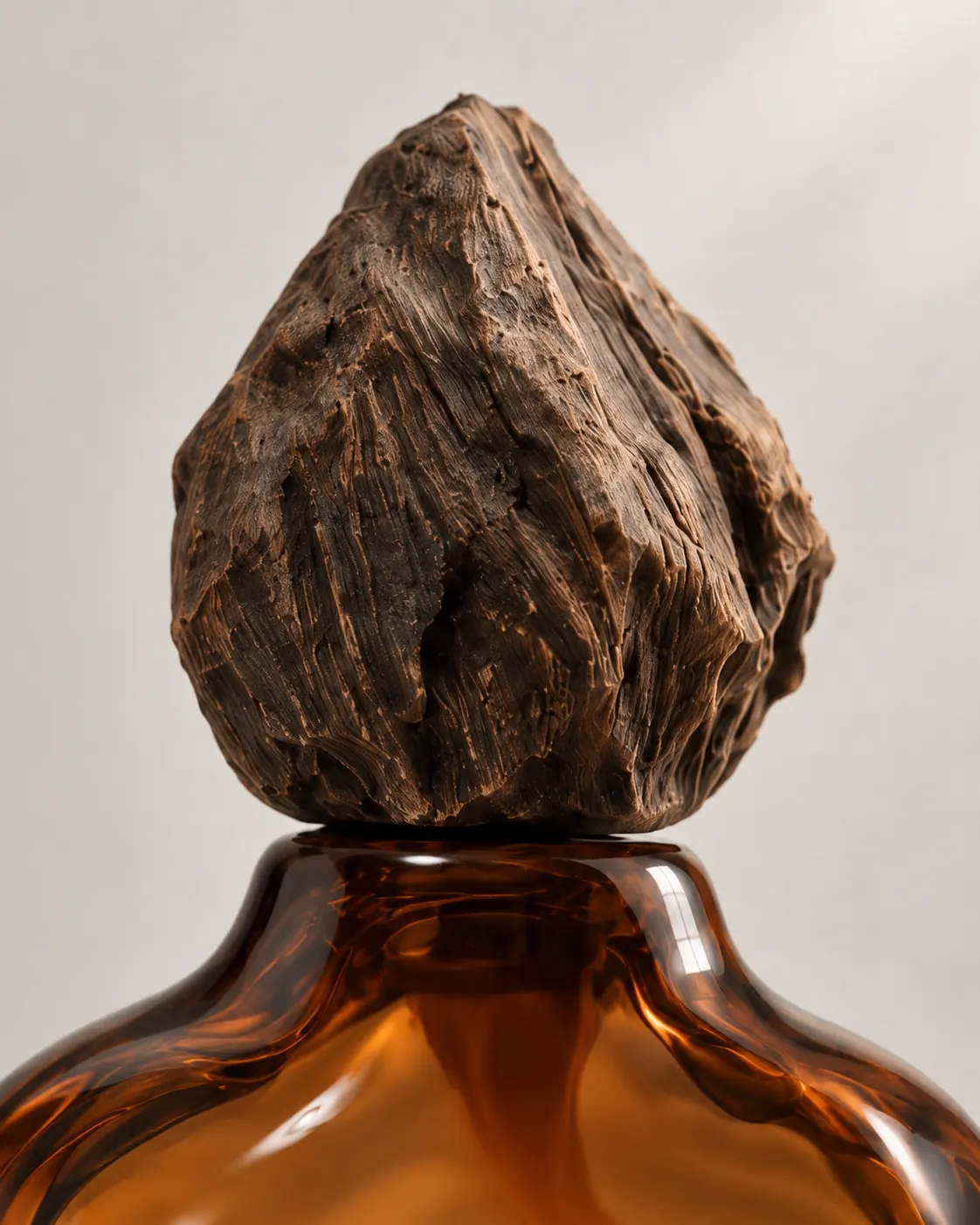 Close-up of the carved wooden cap on the Elemental WOOD bottle