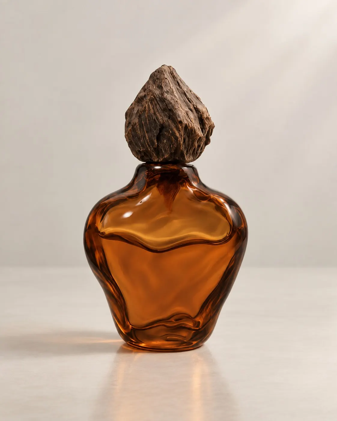 The Elemental WOOD bottle in amber glass beneath its carved wooden cap